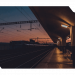 A train station bathed in the warm glow of a sunset, creating a serene and picturesque scene.